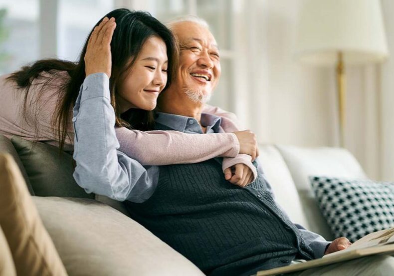 elderly father and adult daughter hanging out