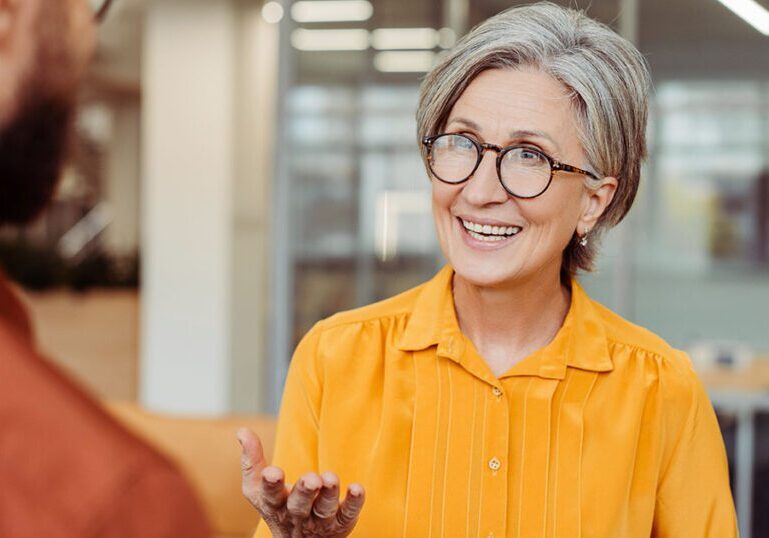 Financial advisor discussing retirement plan options with a client, illustrating tax planning for net unrealized appreciation and after-tax 401(k) contributions.