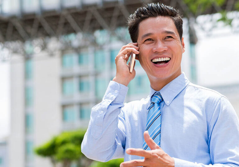 Joyful businessman talks on the phone