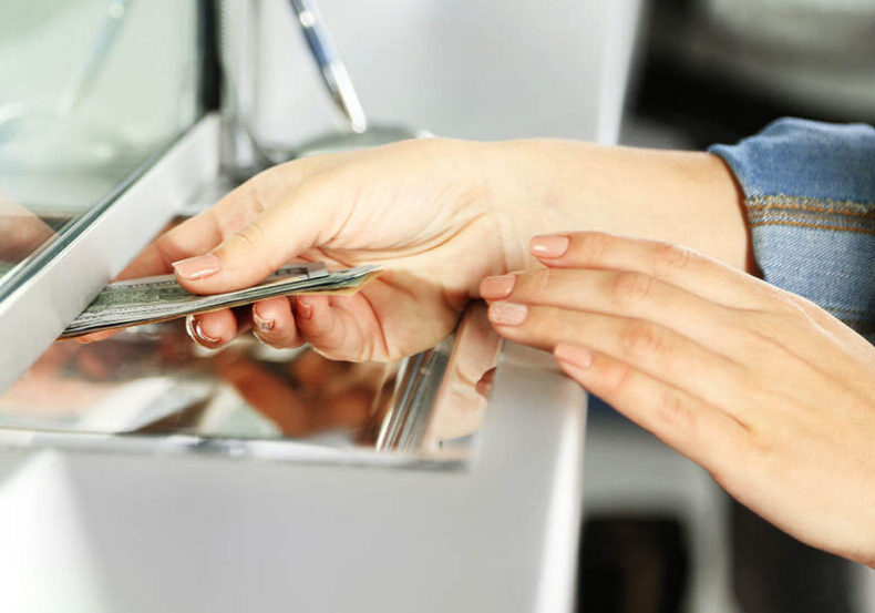 Woman depositing money in a bank or brokerage account