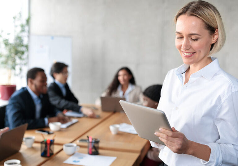 Business owner utilizing technology during a work meeting