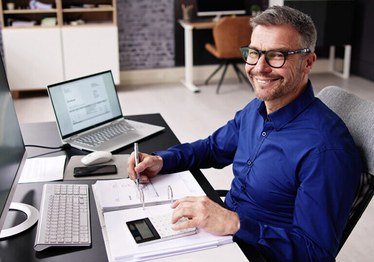 CPA working at a desk going through a business's financials