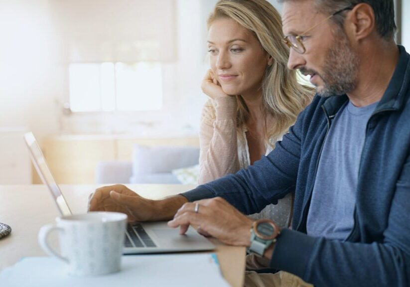 Woman and husband look at laptop
