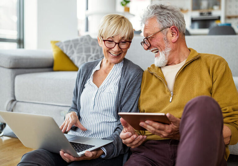 Senior couple looks up Social Security information online