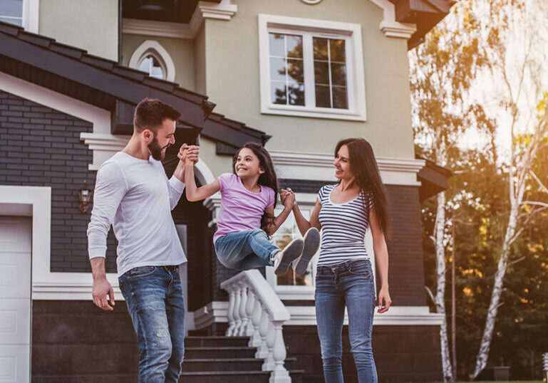 Happy family spends time outside their home