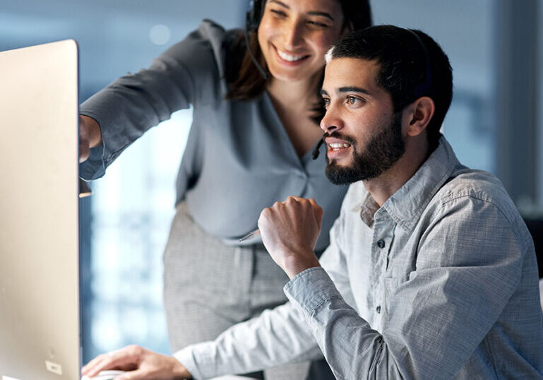 IT provider assisting client with technology issue at his desk