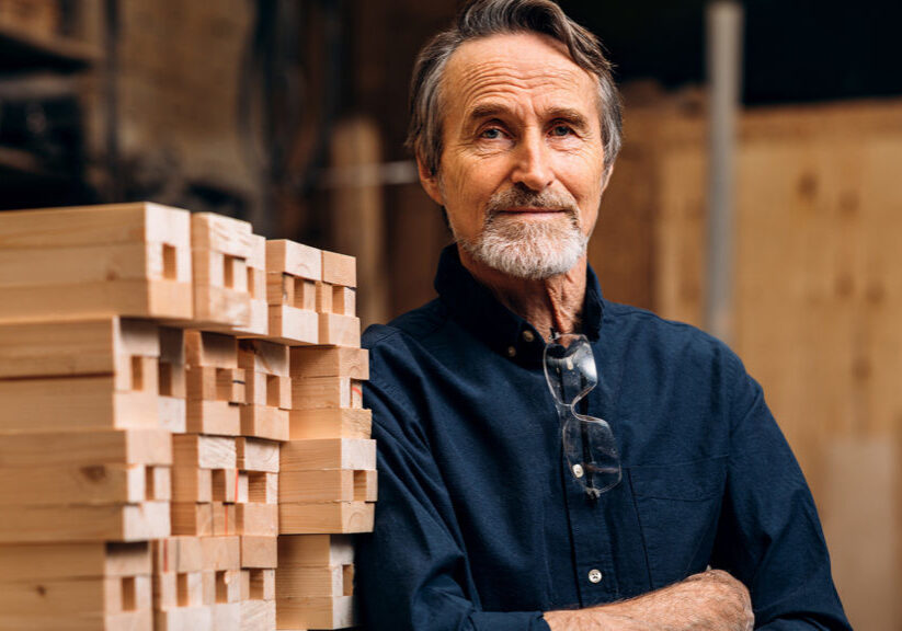 Portrait of confident senior male carpenter standing in his work