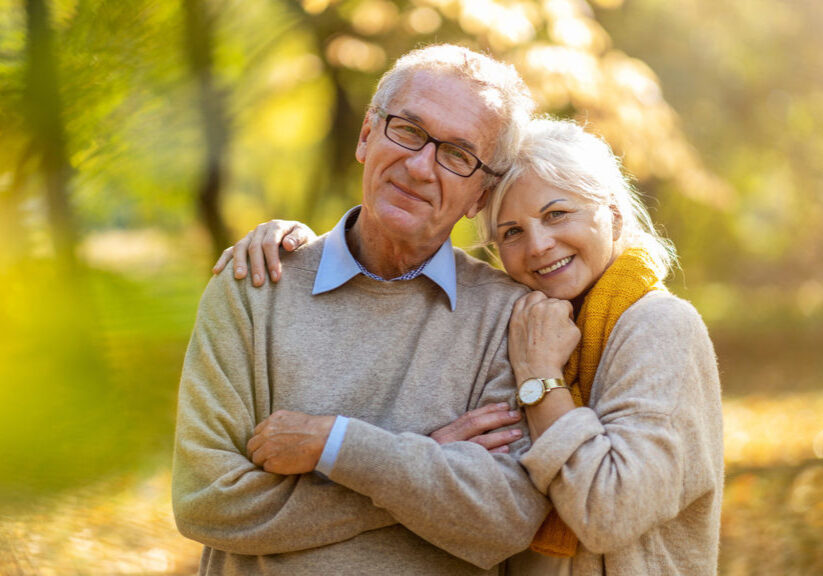 Happy senior couple in autumn park