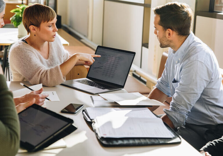 HR team looks at open enrollment data at review meeting