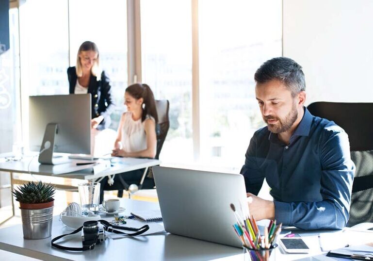 Employee reviewing benefits at his desk