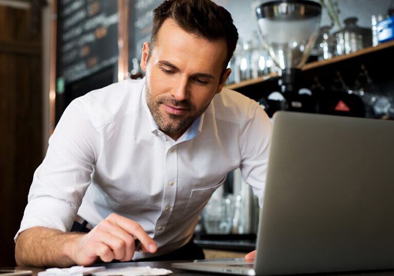 Small restaurant owner going through receipts for his financial records