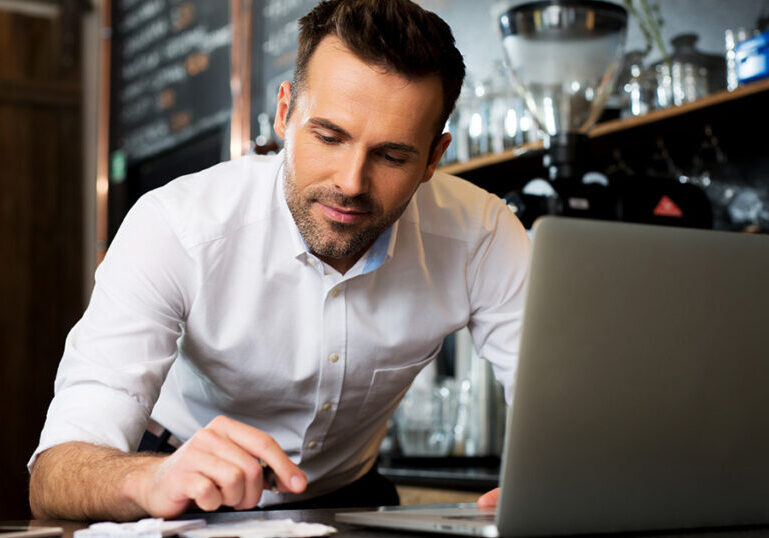 Small restaurant owner going through receipts for his financial records