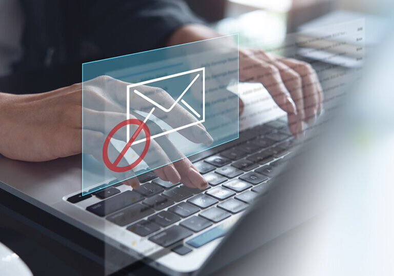 Business person reporting a fraudulent tax email on their computer